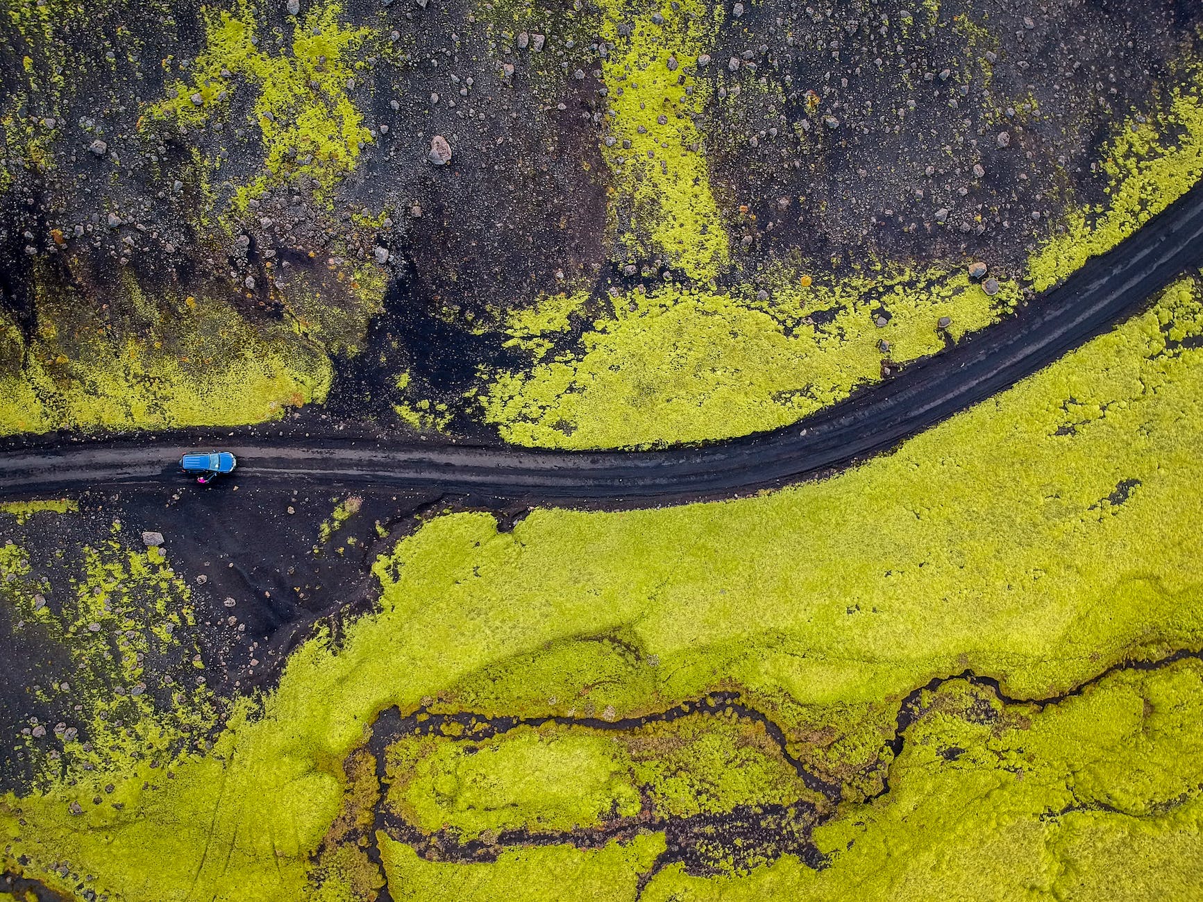 aerial photography of blue vehicle at road