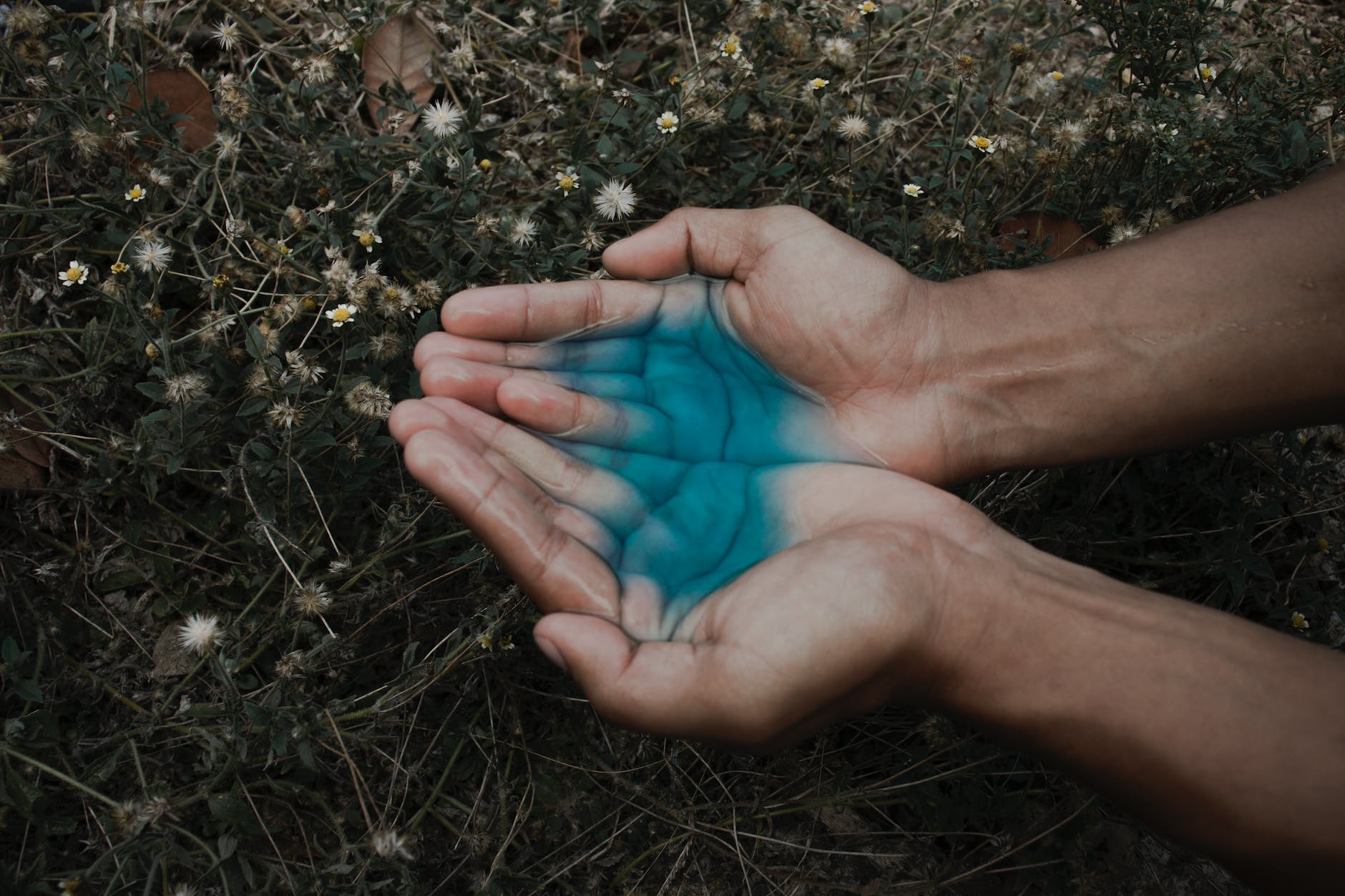 human hand with blue liquid